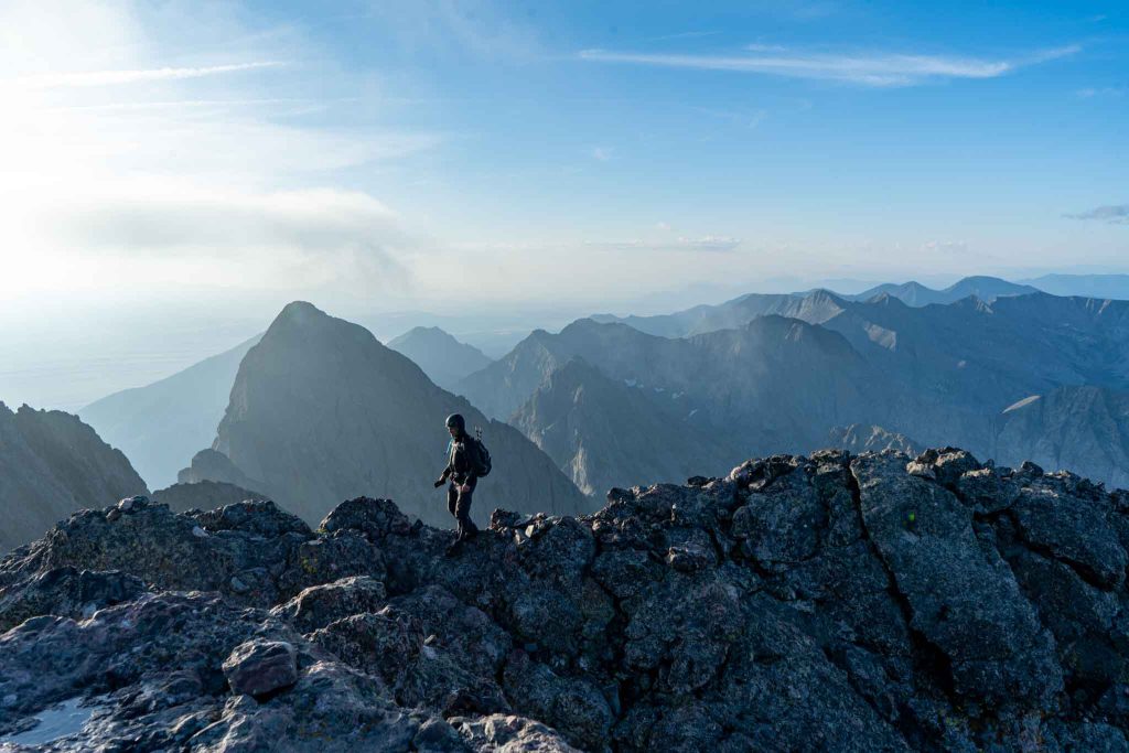 Hiker next to the summit of Crestone Peak